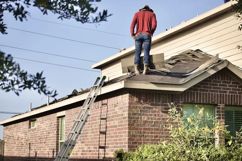 Professional roofer working on a residential roof in Jersey City